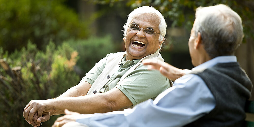 Two men laughing together Image of two men laughing together